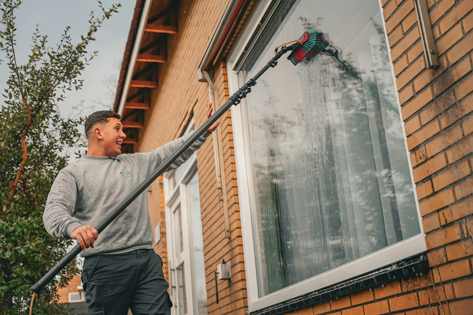Glazenwasser met telescoopsteel voor een woning
